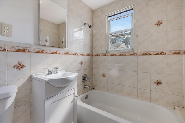 full bathroom with vanity, toilet, tile walls, and tiled shower / bath combo