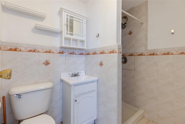 bathroom featuring tiled shower, vanity, tile walls, and toilet