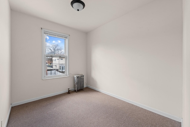 unfurnished room featuring carpet flooring and radiator