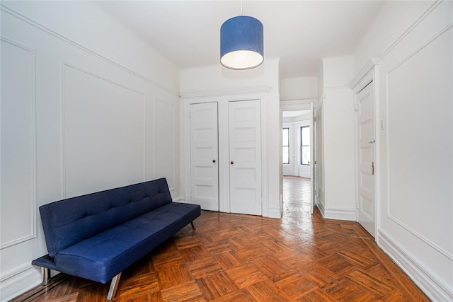 living area with dark parquet flooring