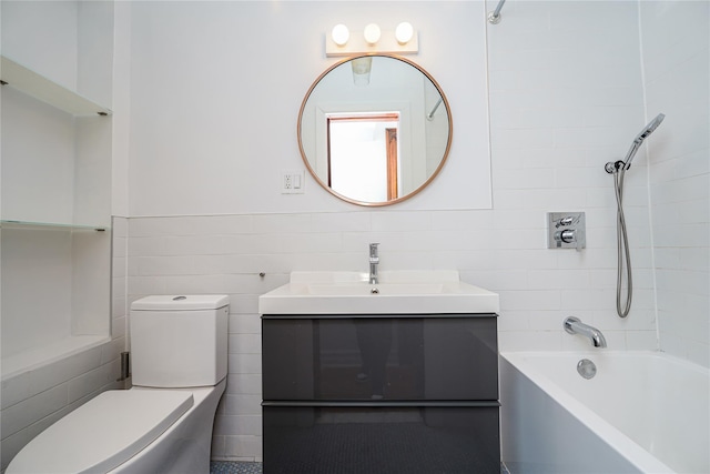 full bathroom featuring vanity, toilet, and tiled shower / bath