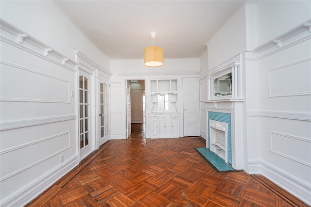 interior space featuring dark parquet flooring and a premium fireplace