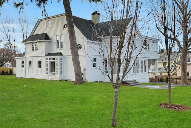 rear view of house with a lawn