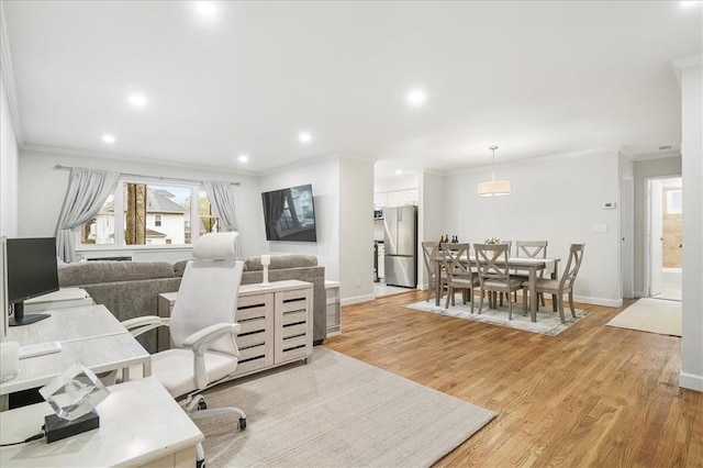 office area with light hardwood / wood-style floors and crown molding