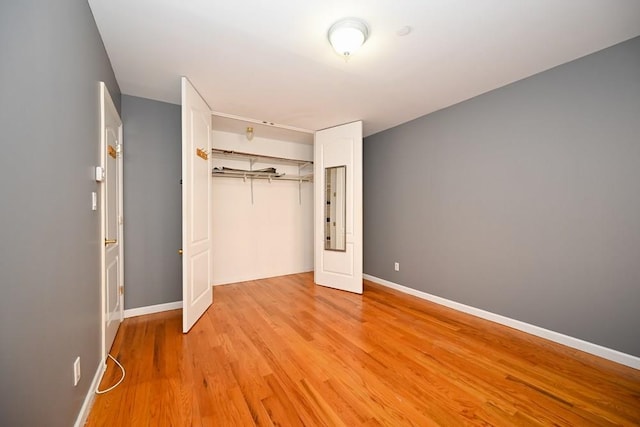 unfurnished bedroom with a closet and light hardwood / wood-style flooring