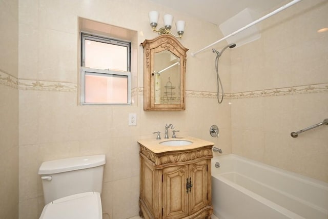 full bathroom with toilet, vanity, tile walls, and tiled shower / bath