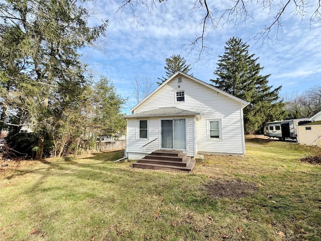 rear view of house with a yard