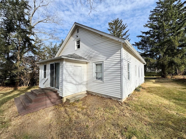 rear view of property featuring a yard