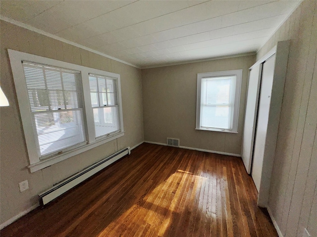 unfurnished room with crown molding, dark wood-type flooring, and a baseboard radiator