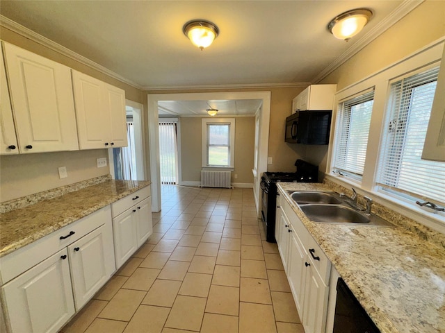 kitchen featuring black appliances, white cabinetry, radiator heating unit, and sink