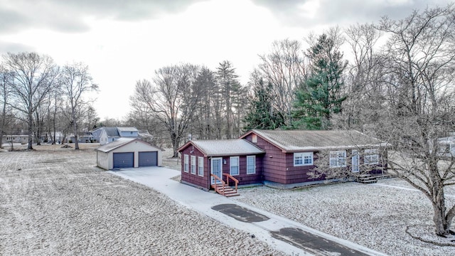 single story home featuring an outbuilding and a garage