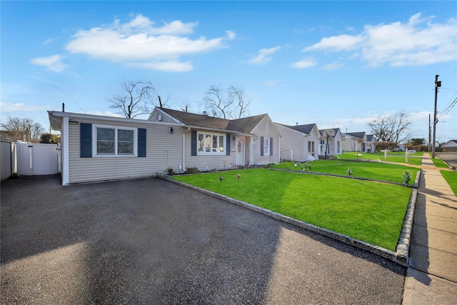 single story home featuring a front lawn