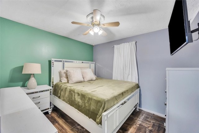 bedroom with dark hardwood / wood-style flooring and ceiling fan