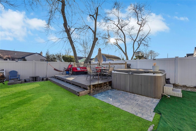 view of yard featuring a wooden deck and a hot tub