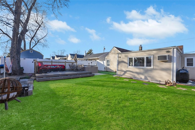 rear view of property with a yard and a deck