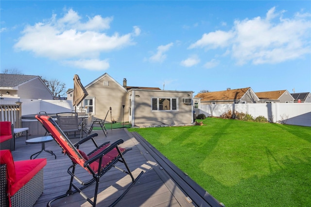 back of house featuring a wooden deck and a yard