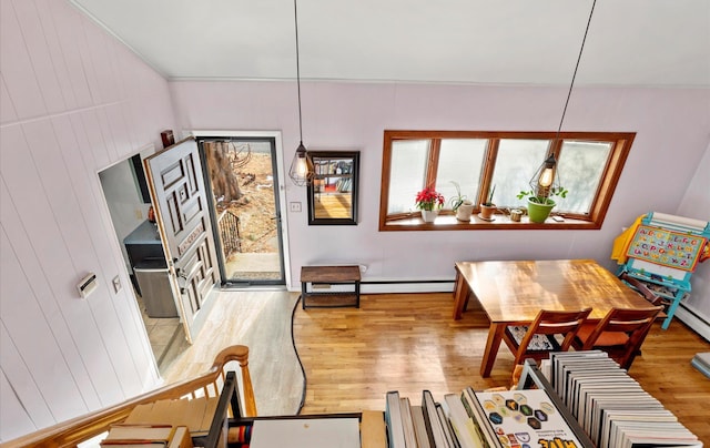 dining space with a wealth of natural light and hardwood / wood-style flooring