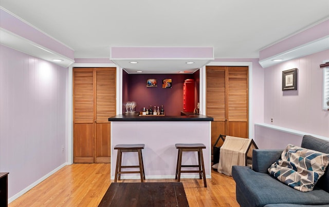 bar with light hardwood / wood-style flooring