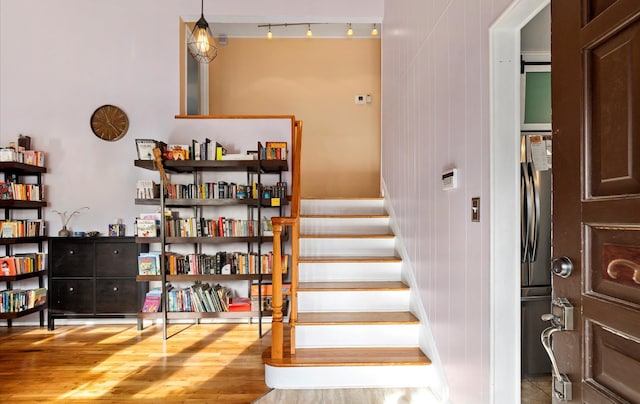 stairs featuring hardwood / wood-style flooring