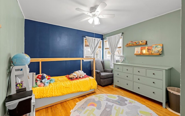 bedroom with ceiling fan and light hardwood / wood-style floors