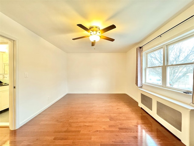 unfurnished room featuring ceiling fan and light wood-type flooring