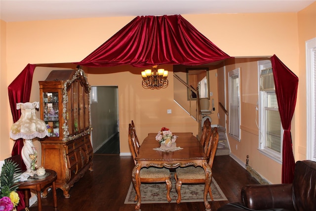 dining space with a notable chandelier and dark hardwood / wood-style flooring