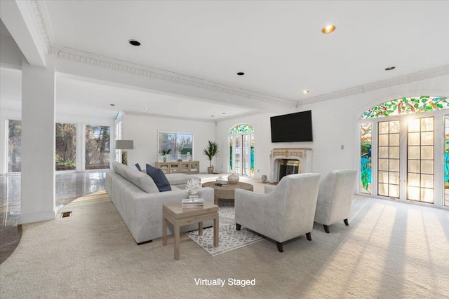 living room with ornamental molding and light colored carpet