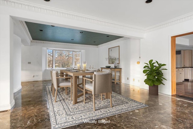 dining space featuring crown molding