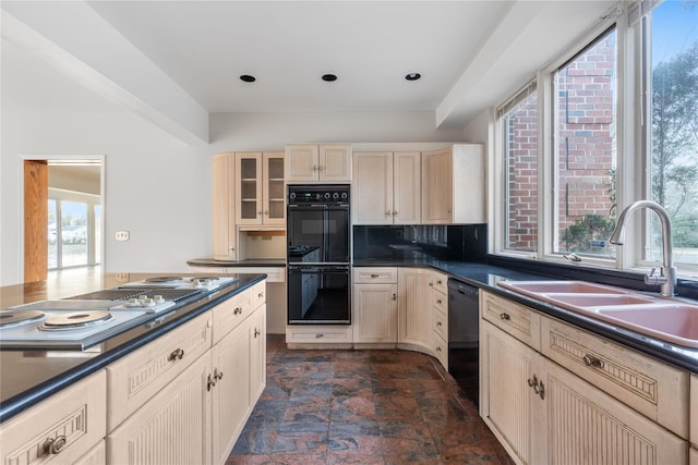 kitchen with backsplash, sink, and black appliances