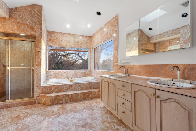 bathroom featuring a skylight and tile walls