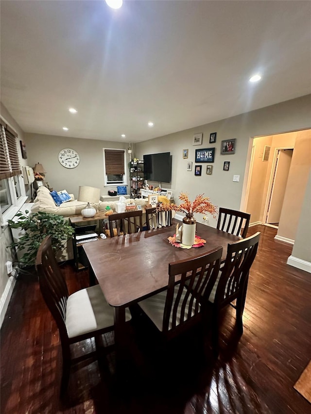 dining space with dark wood-type flooring