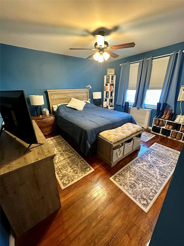 bedroom featuring ceiling fan and dark wood-type flooring