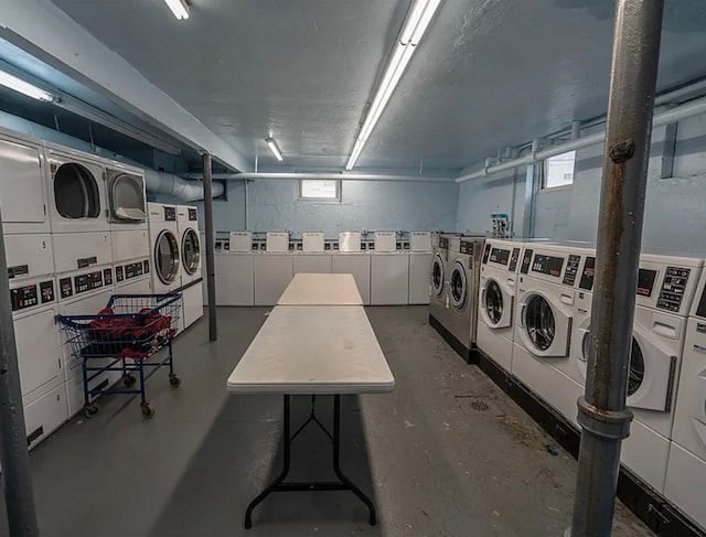 laundry room featuring stacked washer and clothes dryer and washing machine and clothes dryer