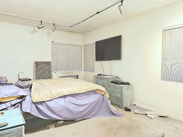 bedroom featuring track lighting