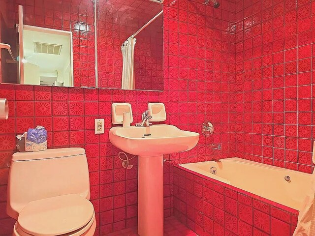 bathroom with toilet and shower / bath combo with shower curtain