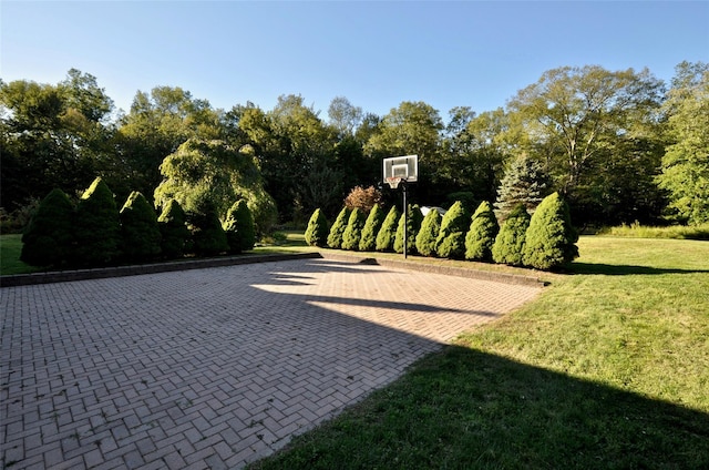 view of patio featuring basketball hoop