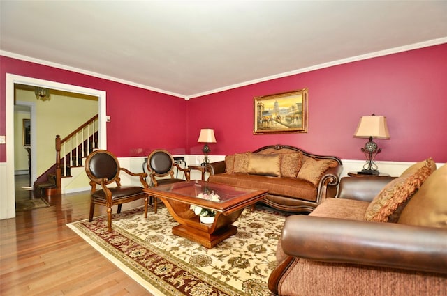 living room featuring wood-type flooring and ornamental molding