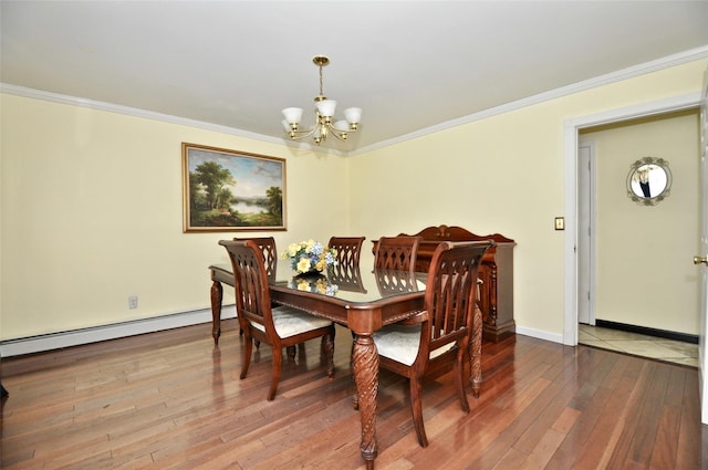 dining room with hardwood / wood-style flooring, a notable chandelier, crown molding, and baseboard heating