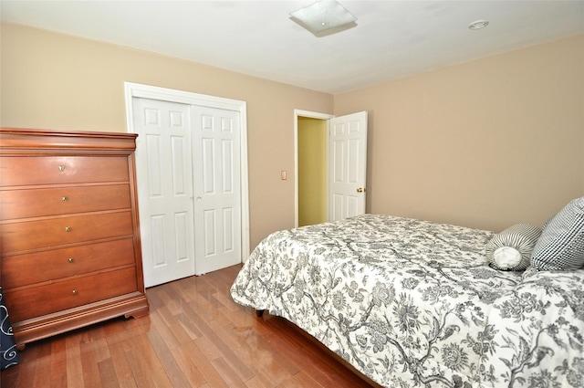 bedroom with a closet and hardwood / wood-style floors