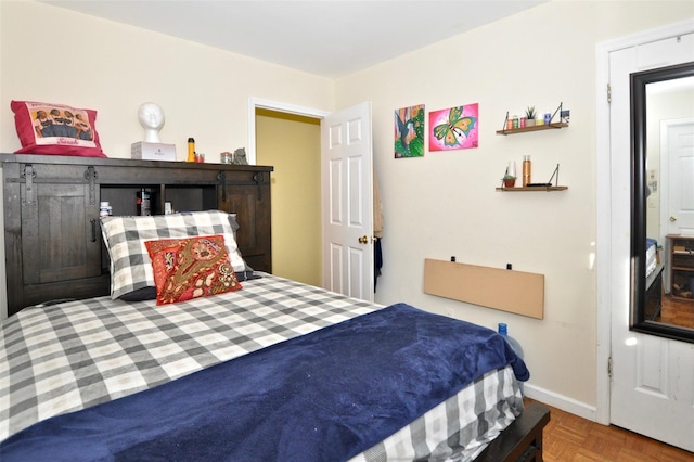 bedroom featuring parquet flooring