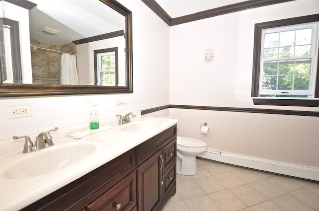 bathroom with tile patterned flooring, vanity, plenty of natural light, and baseboard heating