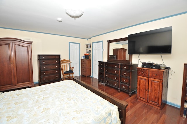 bedroom with dark hardwood / wood-style floors