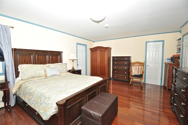 bedroom featuring crown molding and dark wood-type flooring