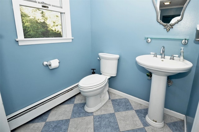 bathroom with sink, toilet, and baseboard heating