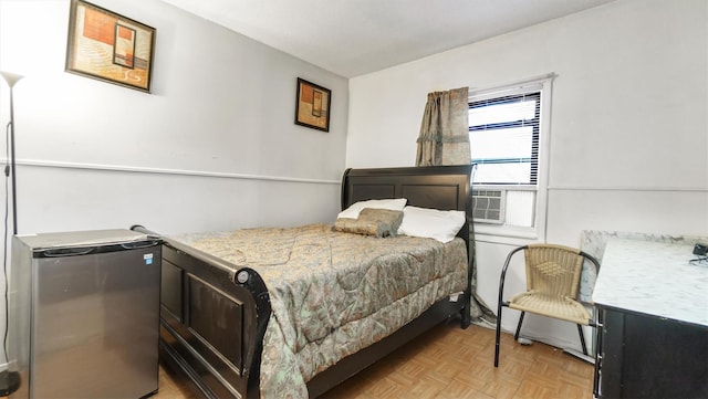 bedroom with cooling unit, light parquet flooring, and fridge