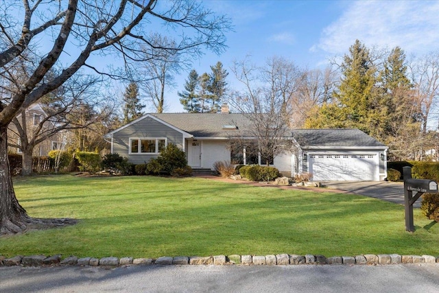 ranch-style home featuring a garage and a front yard