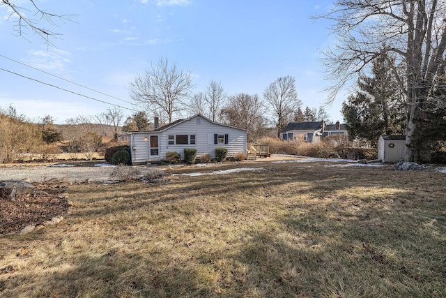 exterior space featuring a shed and a lawn