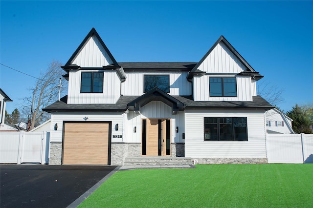 modern farmhouse style home with a front lawn and a garage