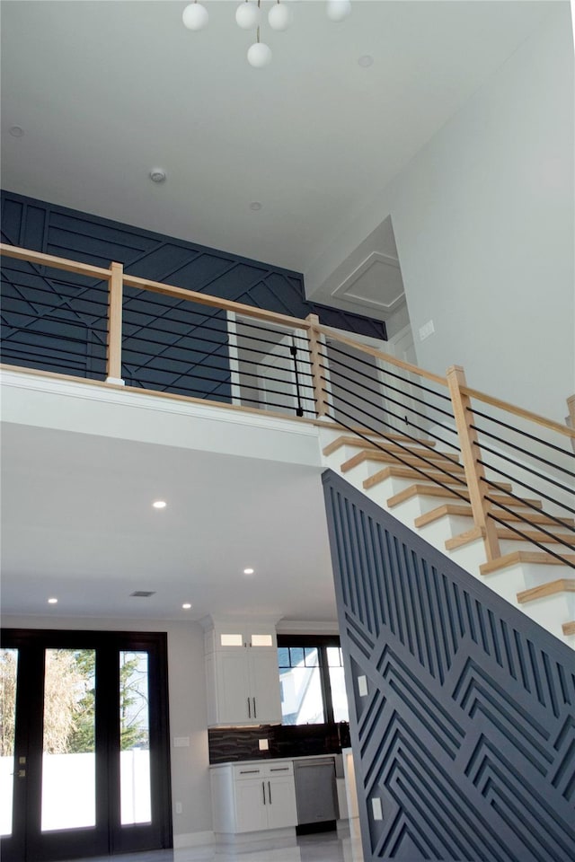 staircase featuring french doors and a wealth of natural light