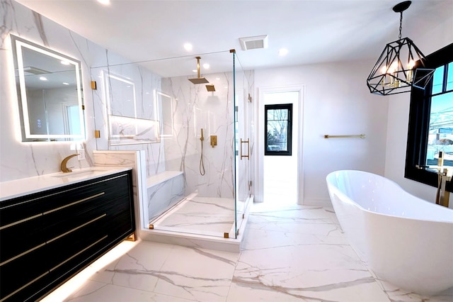 bathroom featuring separate shower and tub, vanity, and an inviting chandelier